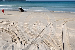 4x4 tyre tracks crisscrossing Tire tracks on the sand texture background in summer day on the beach sand texture