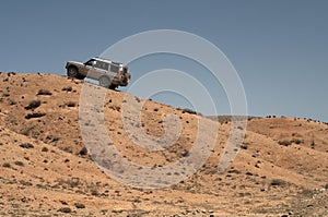 4x4 vehicle driving offroads in steppe