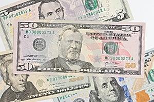 5, 20, 50, 100 dollars banknotes at different angles. Close up of dollars on white background.