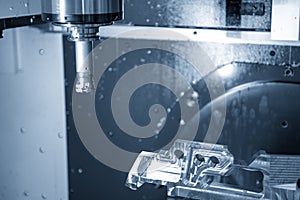 The 5-axis CNC milling machine cutting the aerospace part .