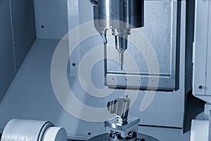 The 5-axis CNC milling machine cutting automotive part .