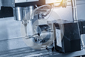 The   5-axis machining center  cutting the sample part with rotary attachment.