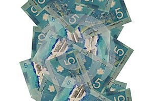 5 Canadian dollars bills flying down isolated on white. Many banknotes falling with white copyspace on left and right side