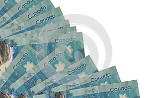 5 Canadian dollars bills lies isolated on white background with copy space stacked in fan close up