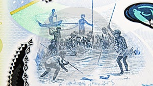 5 Dollars polymer banknote, Bank of Solomon Islands, closeup bill fragment shows men spear fishing