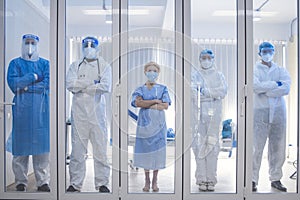 5 of Dortor, Nurse and patient looking out in the quarantine room - Covid 19 Concept