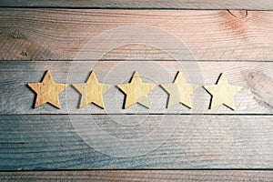 5 Golden Stars Lying Down On Wooden Board - View From Above - Top Quality Concept