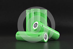 5 green cylindrical batteries on a black background. Storage battery or secondary cell. Rechargeable li-ion batteries