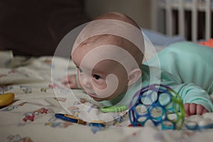 A 5-months-old baby playing with toys