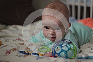 A 5-months-old baby playing with toys