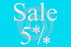 5 percent sale on a blue background, top view. Background for Christmas, new year, and winter sales. Seasonal discounts in stores