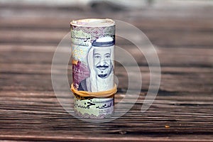 5 SAR five Saudi riyals cash money banknote bills rolled up with rubber bands with the photo of king Salman