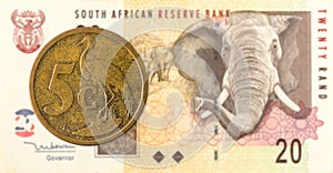 5 south african aforika coin against 20 south african rand