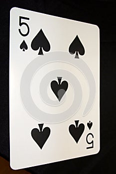 The 5 of spades from the deck of cards.