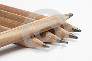 5 wooden pencils macro shot, isolated on whte