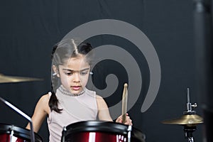 5 year old girl practices the drums