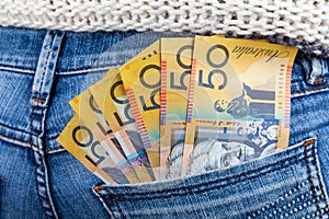 50 AUD bills placed in jeans back pocket.