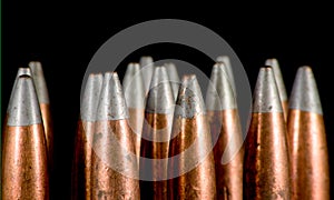 .50 BMG bullets on black photo