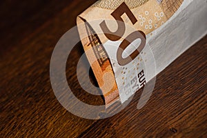 50 euro banknote on wooden table, close up