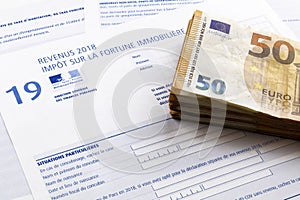 50 euro banknotes on a French Property wealth tax form