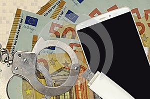 50 euro bills and smartphone with police handcuffs. Concept of hackers phishing attacks, illegal scam or malware soft distribution