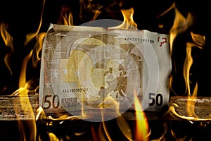 50 Euro money bill on wood just about to burn