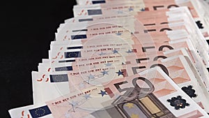 50 euros money falling against black background