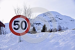 50 kph speed limit sign, Hovden, Norway. Sign against snowy background. Feb 2023.