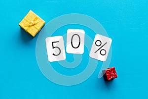 50% off discount - sale concept with present box - on blue background top-down copy space