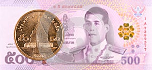 50 thai satang coin against 500 new thai baht banknote