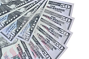 50 US dollars bills lies isolated on white background with copy space stacked in fan shape close up