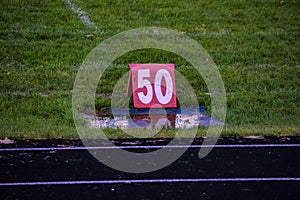 50 yard line marker at a high school football game.