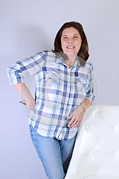 50 year old woman posing portrait white chair