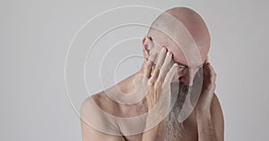 50 years old man having headache touching temples