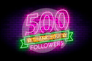 500 followers neon sign on the wall.