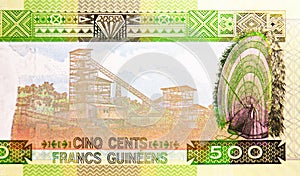 500 Francs banknote. Bank of Guinea. National currency. Fragment: Mining facility, Headwear