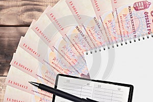 500 Hungarian forint bills fan and notepad with contact book and black pen. Concept of financial planning and business strategy