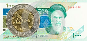 500 iranian rial coin against 10000 iranian rial note obverse