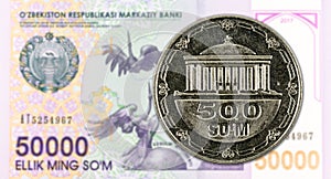 500 Uzbek Som coin against 50000 Uzbek Som banknote