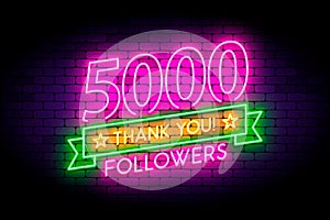 5000, 5K followers neon sign on the wall.