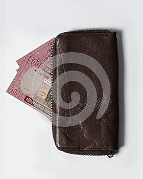 5000 Rwandan franc notes inside a purse