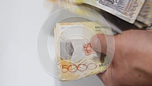 5000 tenge being counted