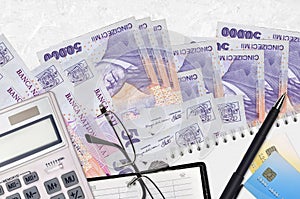 50000 Romanian leu bills and calculator with glasses and pen. Tax payment concept or investment solutions. Financial planning or
