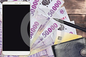 50000 Romanian leu bills and smartphone with purse and credit card. E-payments or e-commerce concept. Online shopping and business
