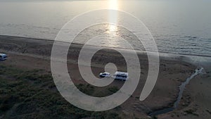 50fps aerial Sunset Couple with dog on Outdoor vacation caravan campsite camper on Melby beach, Sweden by the ocean