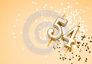 54 years celebration festive background made with golden candle in the form of number Fifty-four