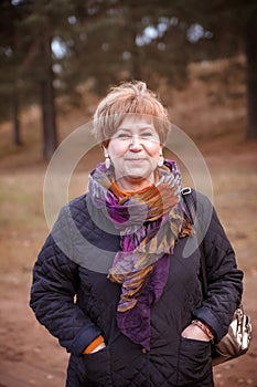 55-year-old woman walks in   pine forest