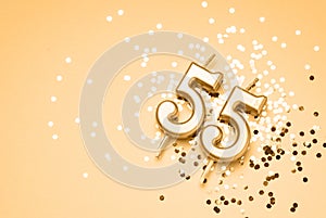 55 years celebration festive background made with golden candle in the form of number Fifty-five