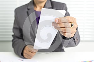 55 years old female businesswoman holds a bill.