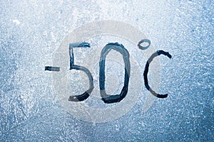 -58 degrees Fahrenheit or -50 Celsius number lettering on icy glass covered with ice and frost. The concept of extreme cold